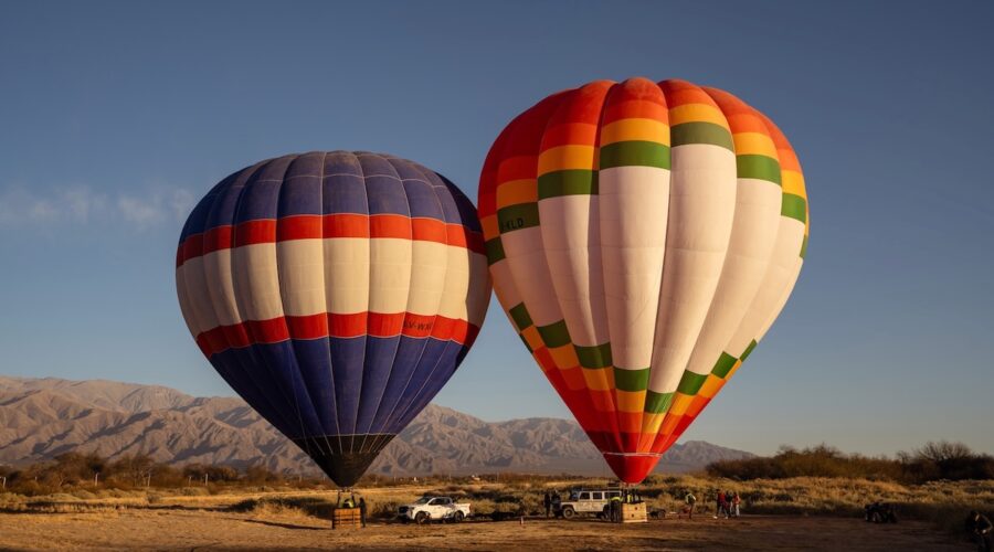 Two hot air balloons preparing for sunrise flight in Cafayate with Wine Tours in Style.