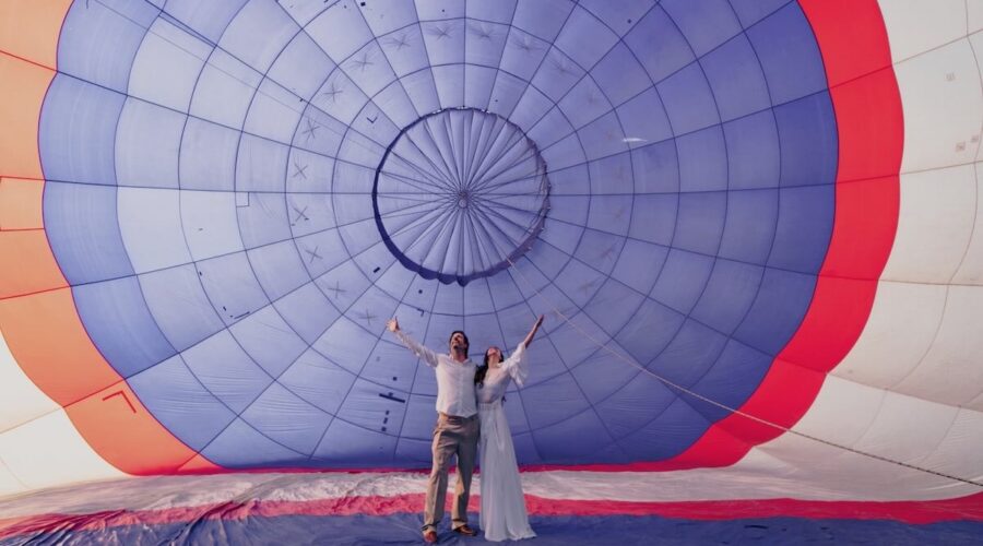 Wedding couple standing inside a hot air balloon before takeoff in Cafayate, celebrating love and freedom with Wine Tours in Style.